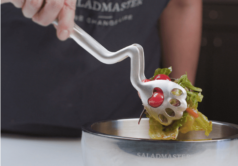 Serving fresh salad in Saladmaster’s premium non-toxic bowl during a healthy cooking demo with chemical-free cookware.