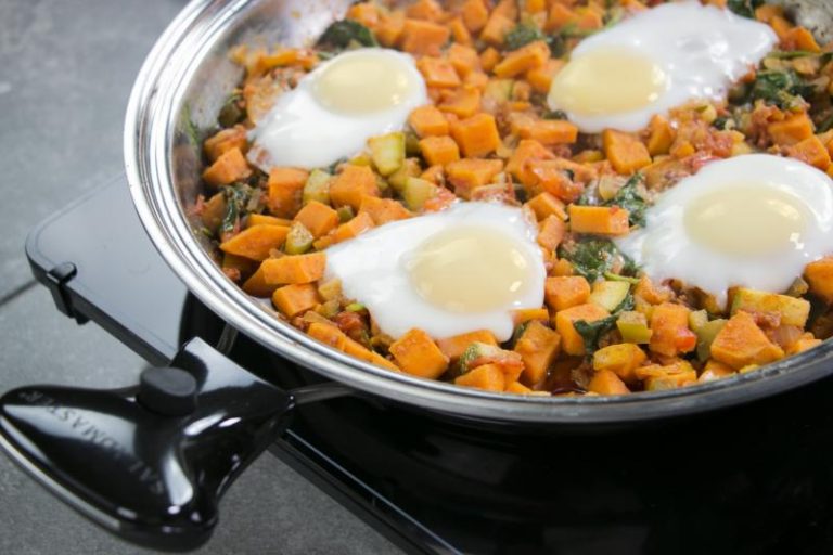 Saladmaster Skillet with cooked vegetables and eggs, demonstrating healthy cooking with non-toxic cookware.