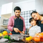 Family cooking with fresh vegetables and Saladmaster cookware during a healthy cooking class at the Cook School in Penrith.