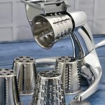 Saladmaster Food Processor with five stainless steel cutting cones on a blue kitchen benchtop