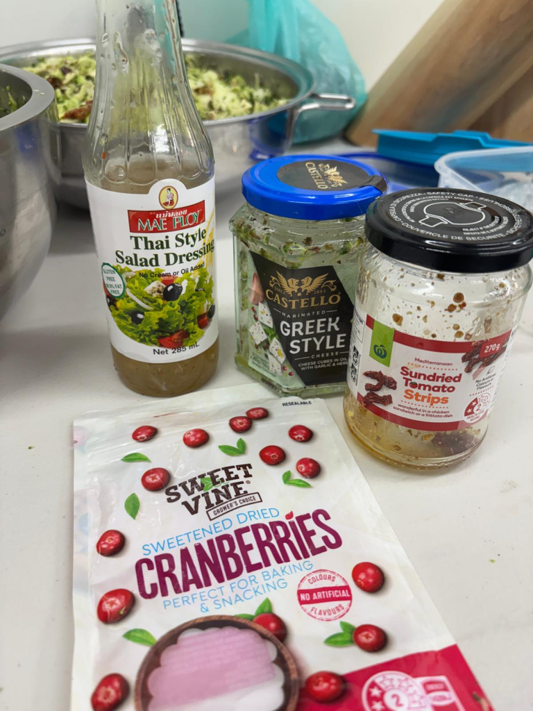 Ingredients for Healthy Broccoli Salad Recipe with Saladmaster cookware – broccoli, red onion, Greek cheese, cranberries, pine nuts, Thai dressing
